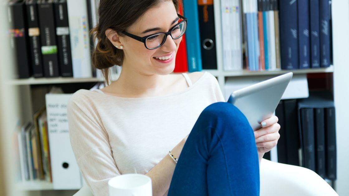 Walnut desk organizer set with white modular trays, next to porcelain mug on wooden desk.